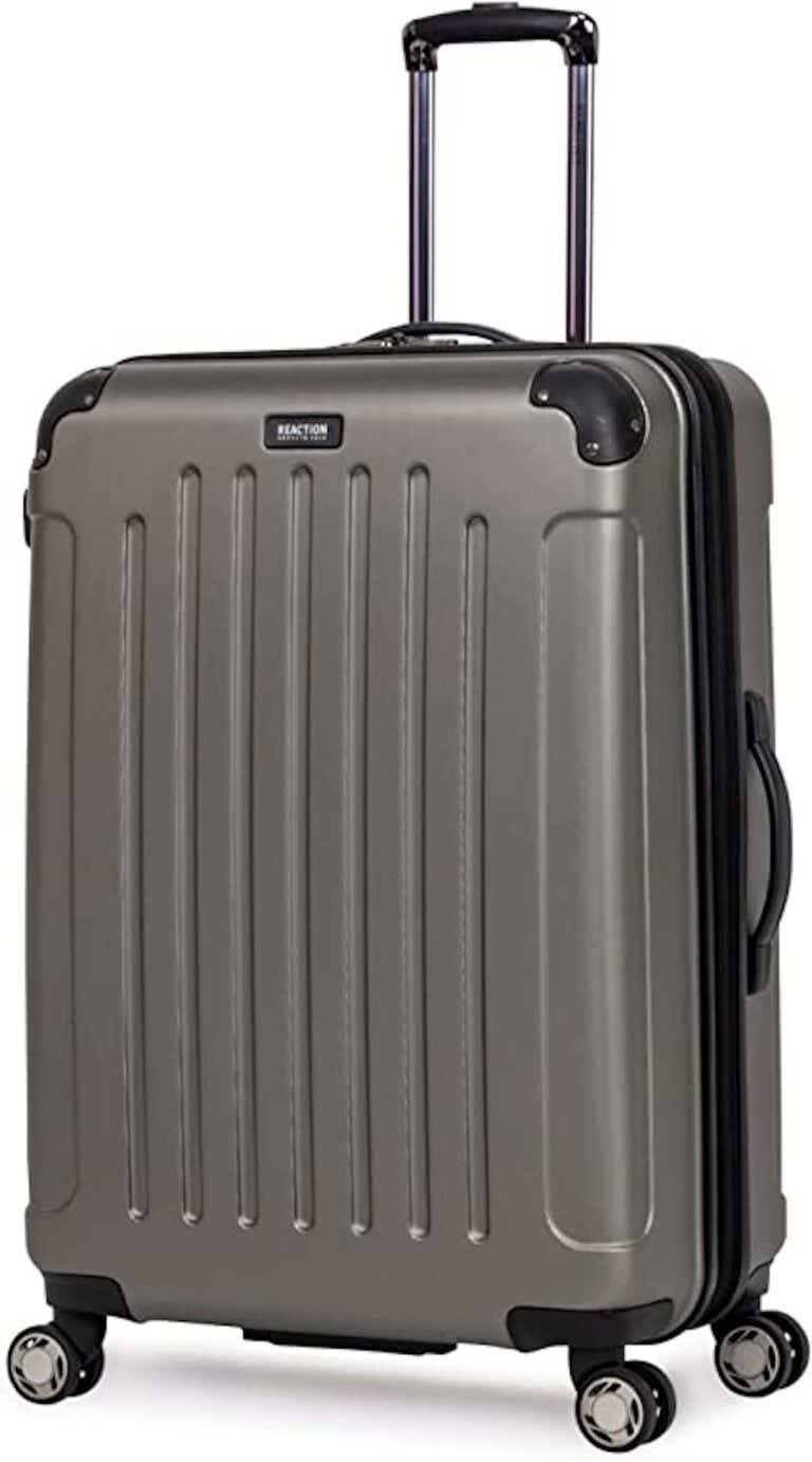 A grey, hardsided suitcase pictured in front of a white background.