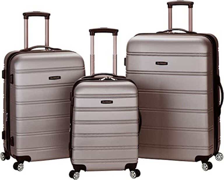 Three hardsided suitcases of different sizes set against a white background.