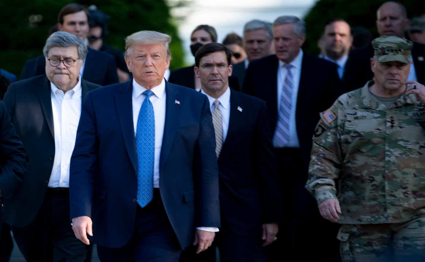US President Donald Trump walks with US Attorney General William Barr (L), US Secretary of Defense Mark T. Esper (C), Chairman of the Joint Chiefs of Staff Mark A. Milley (R), and others from the White House to visit St. John's Church, Lafayette Square, after the area was cleared of people protesting the death of George Floyd June 1, 2020, in Washington, DC.
