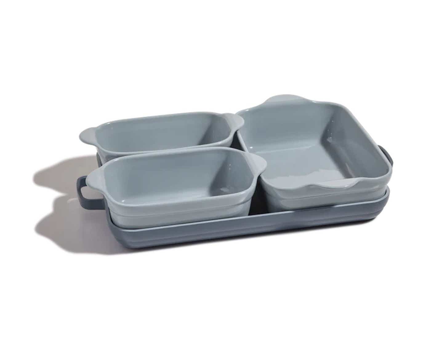 A four piece set of rectangular ovenware nestle inside of the biggest piece of ovenware.