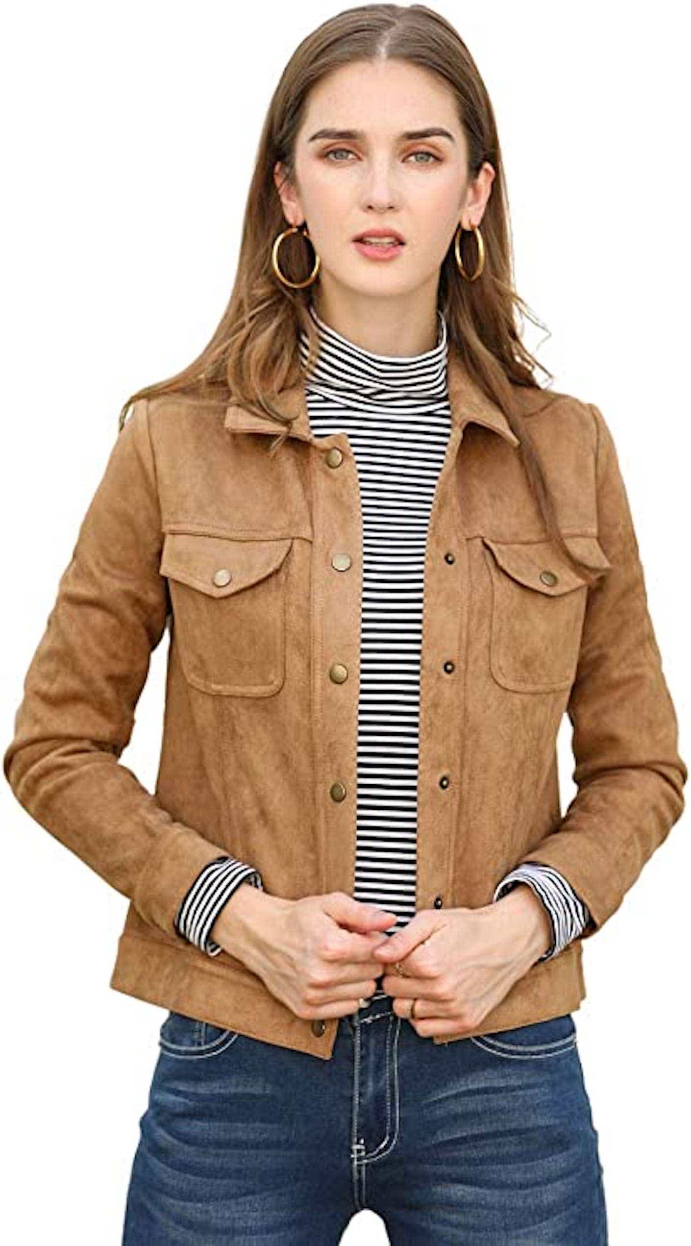 A woman wears a button down faux suede leather jacket that is fitted.