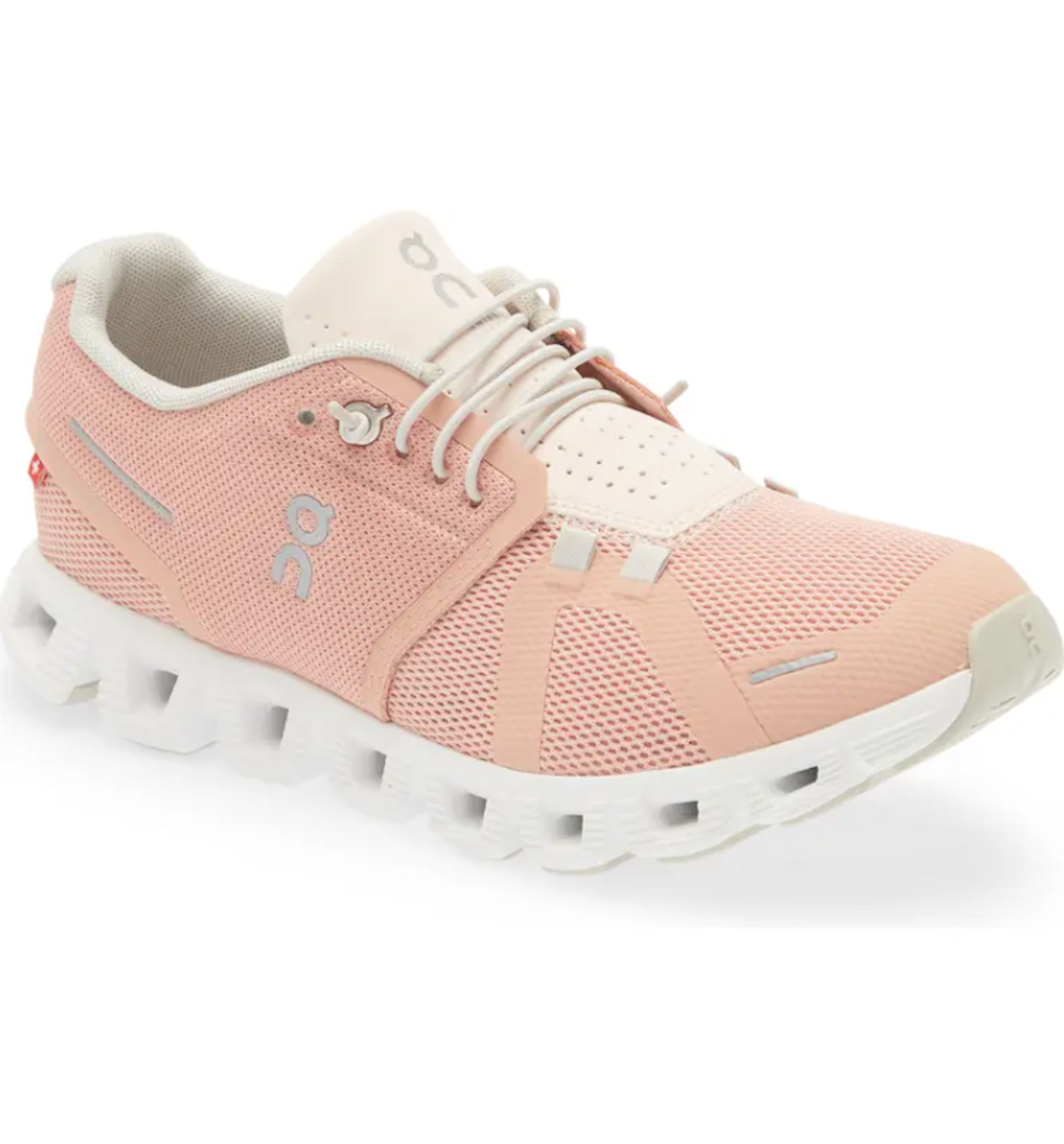 A pair of mesh pink workout shoes with white details pictured in front of a white background.