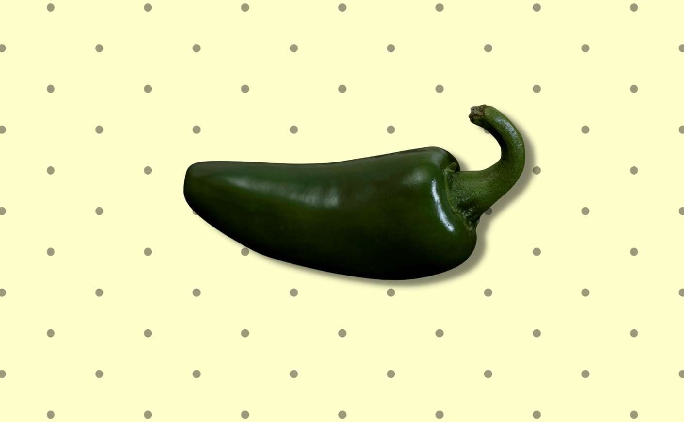 a jalapeno on a polka dot background