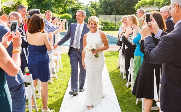 john molner and katie couric walking down the aisle at their wedding