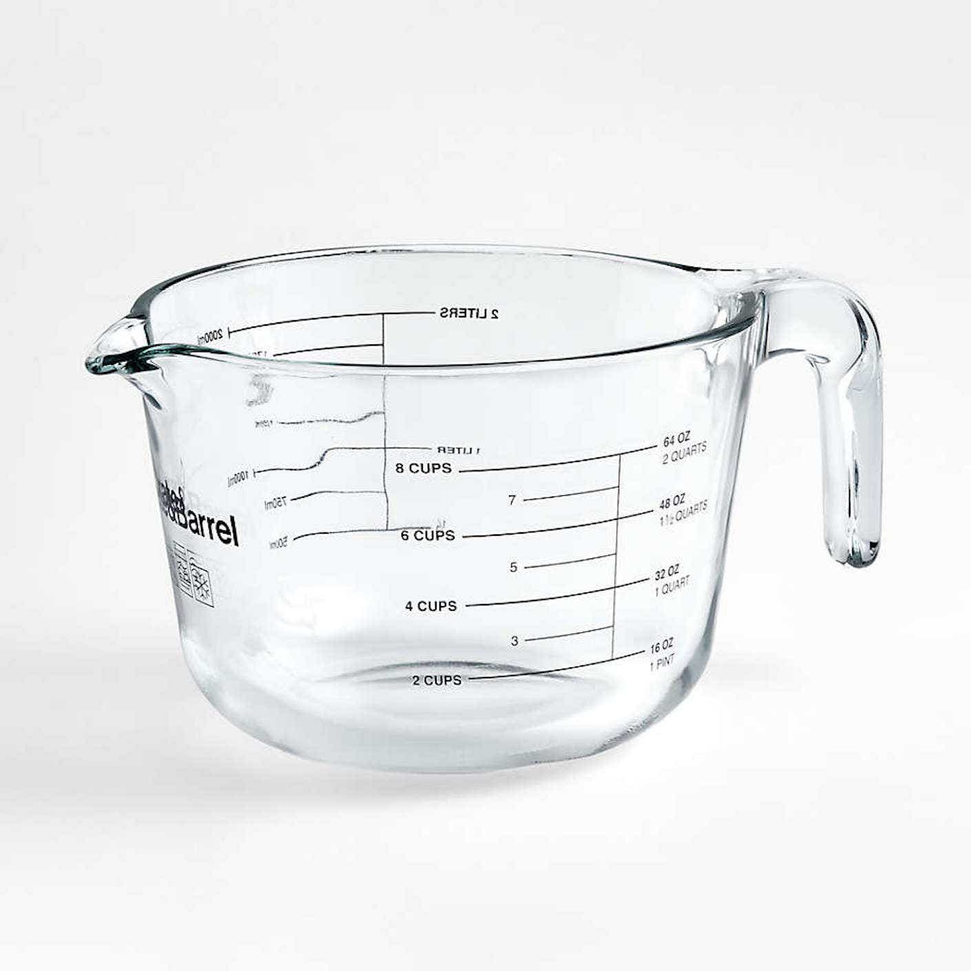 A clear glass 8 cup liquid measuring cup with a handle and a spout is pictured in front of a white background.