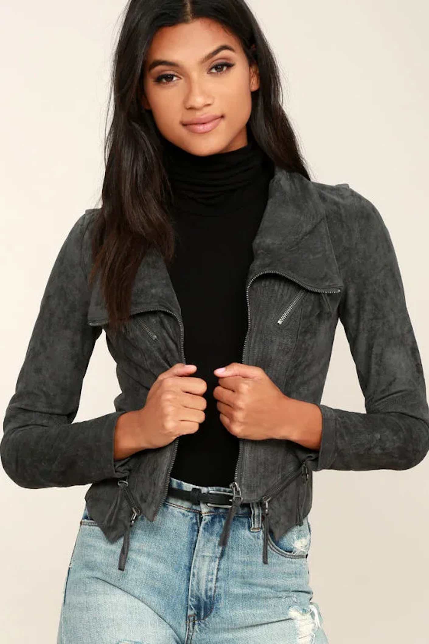 A woman wears a fitted, suede moto jacket that is a soft charcoal gray.
