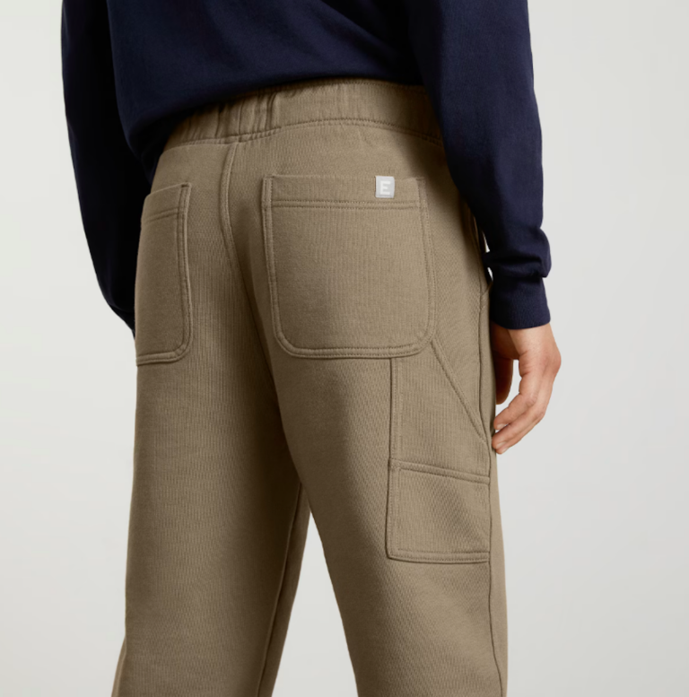 The back of a pair of structured brown sweatpants, featuring large pockets.