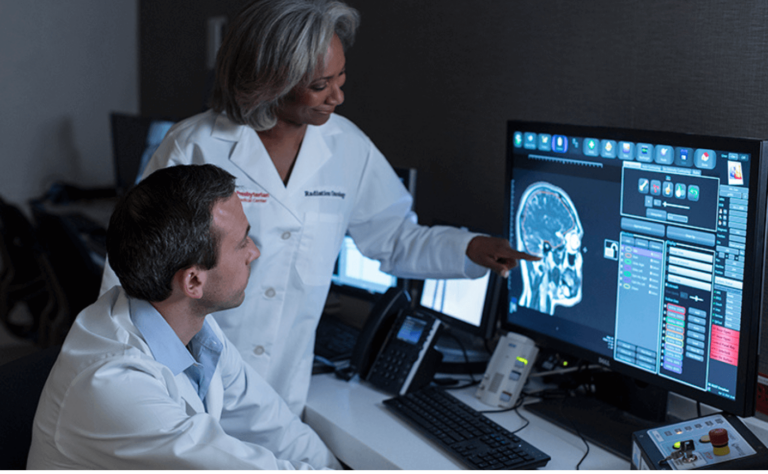 doctors standing at an MRI machine
