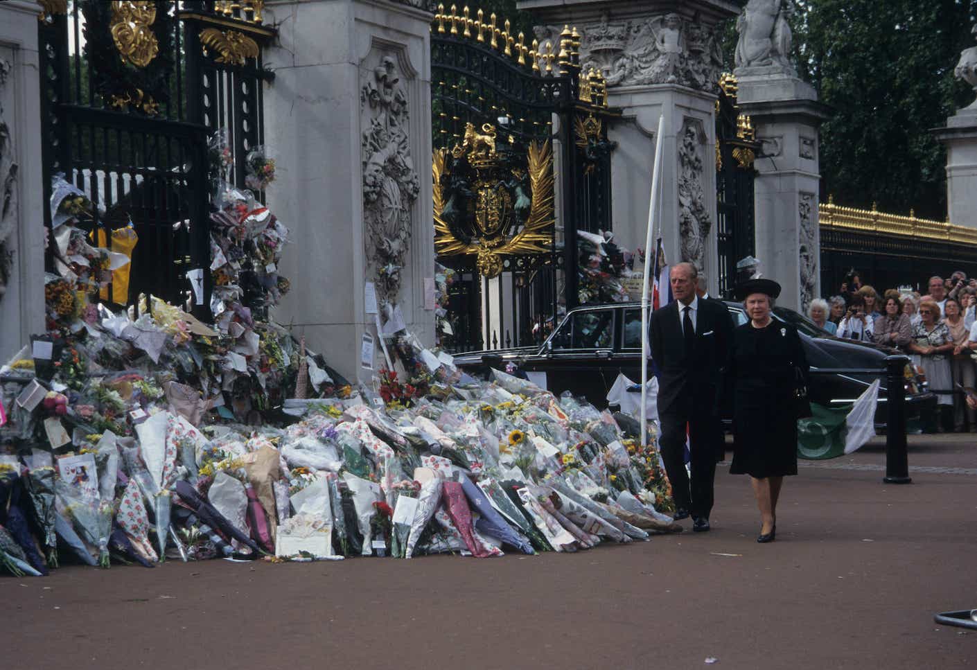 Queen Elizabeth II and Prince Philip walk past floral tributes to the late Princess Diana before the public funeral in 1997.