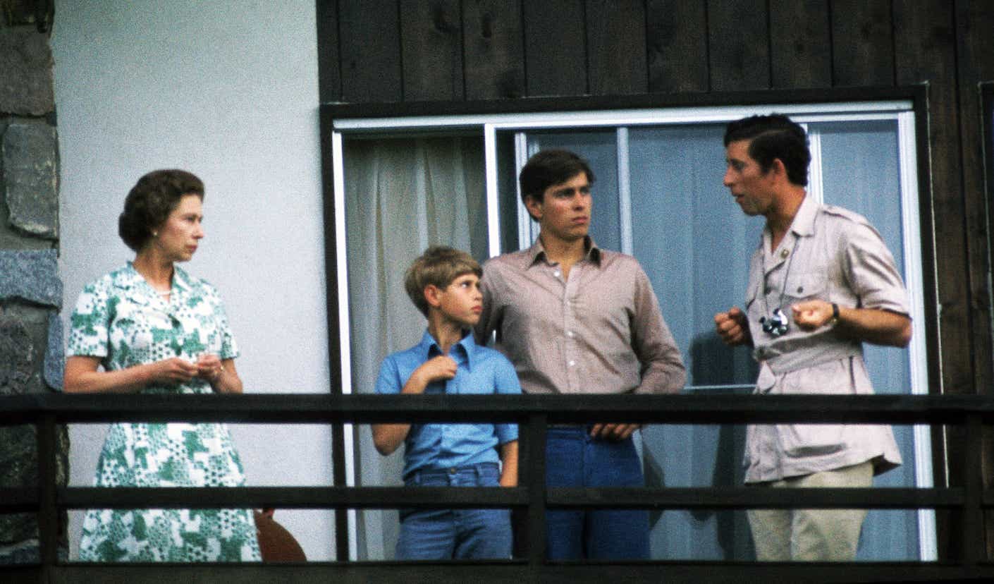 Queen Elizabeth ll relaxes with her three sons, Prince Edward, Prince Andrew and Prince Charles on a balcony.