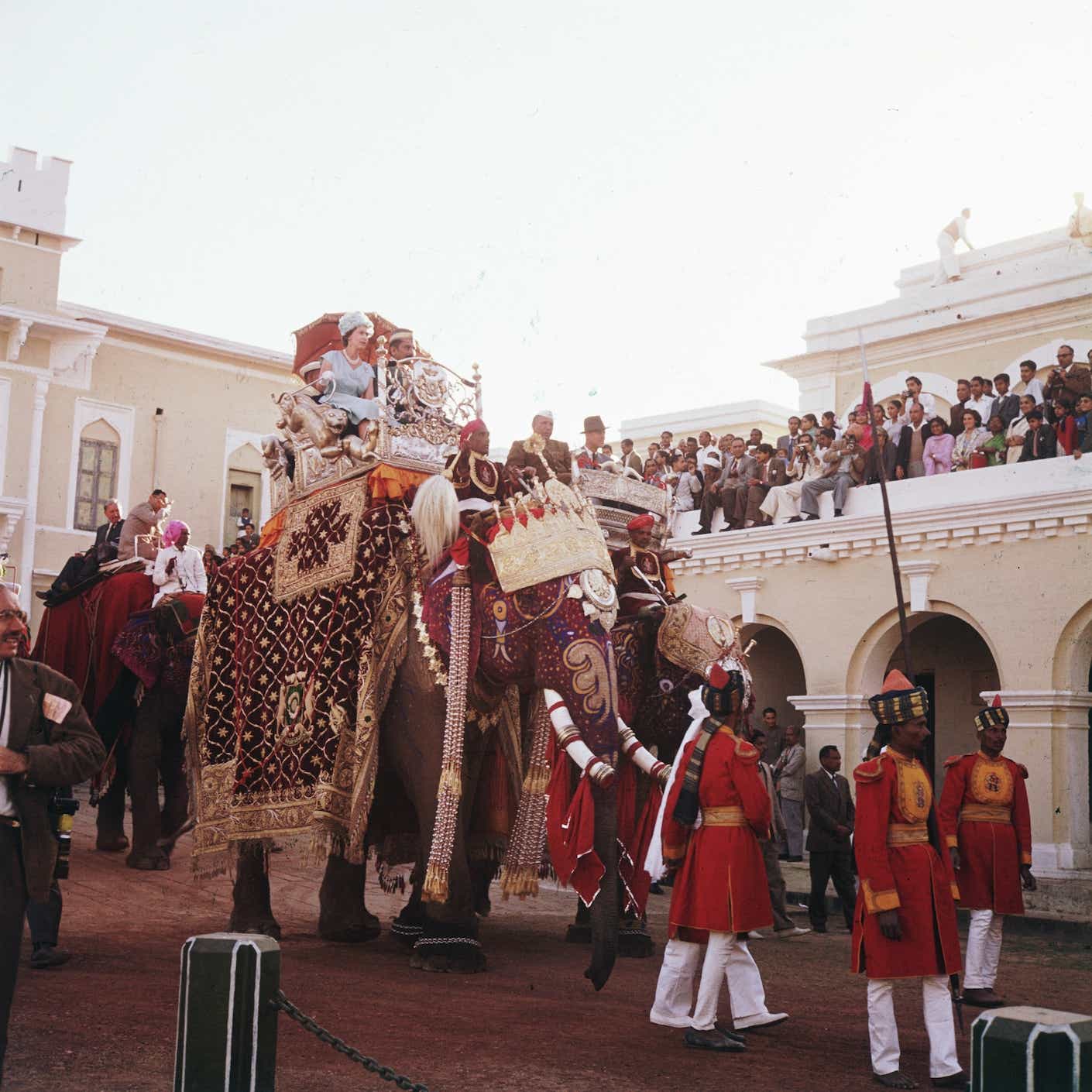 Queen Elizabeth II enjoys an elephant ride at Benares during a tour of India in 1961.