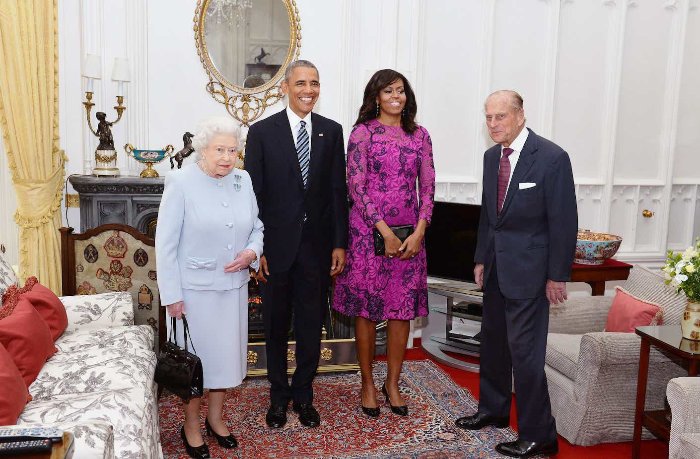 Queen Elizabeth II and Prince Philip stand with US President Barack Obama and First Lady of the United States, Michelle Obama in the Oak Room at Windsor Castle in 2016.