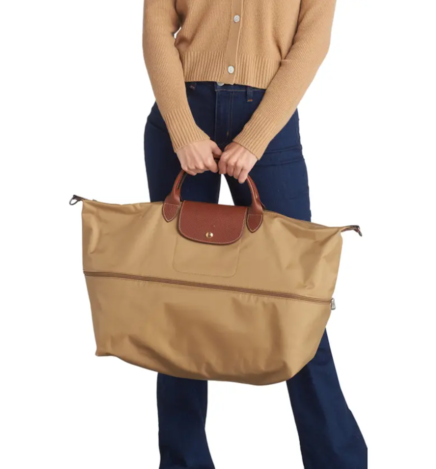 A person carries a large, soft, expandable, light brown bag.