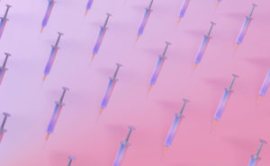 hypodermic needles on a pink background