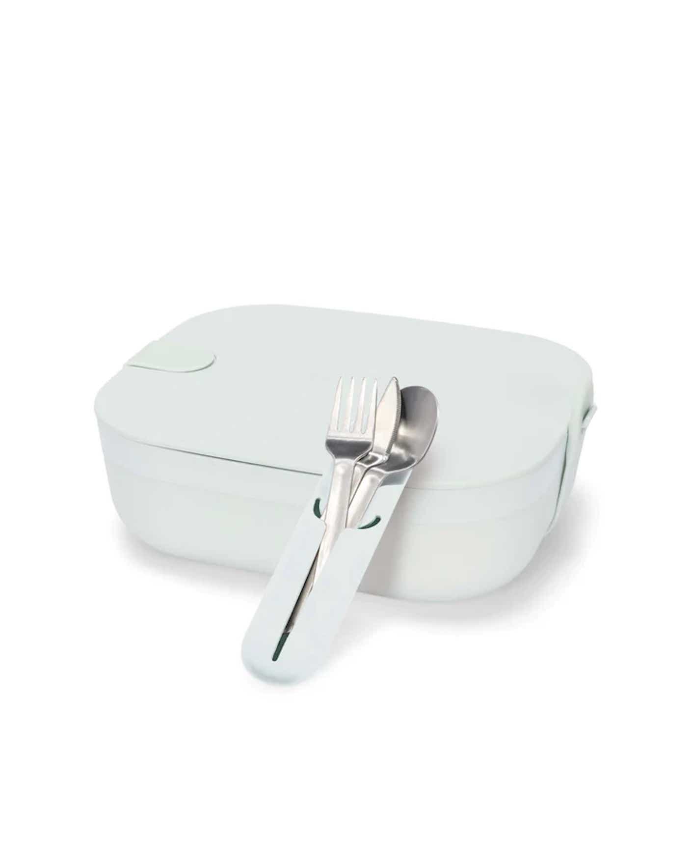 A rigid, rectangular Bento-inspired lunch box comes with a silverware set that includes a fork and spoon in a silicone sleeve.
