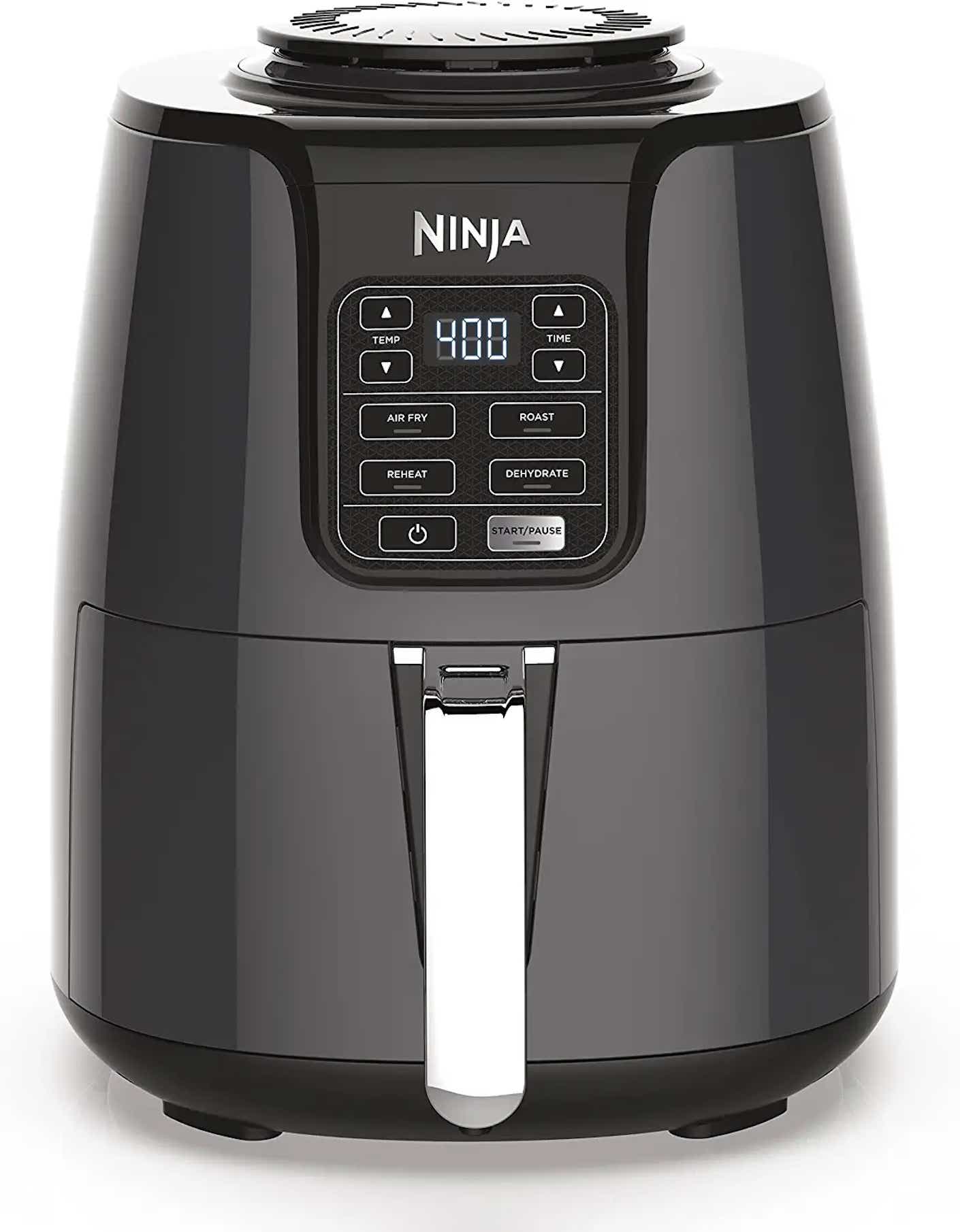 A black air fryer with a silver handle sits in front of a white background.