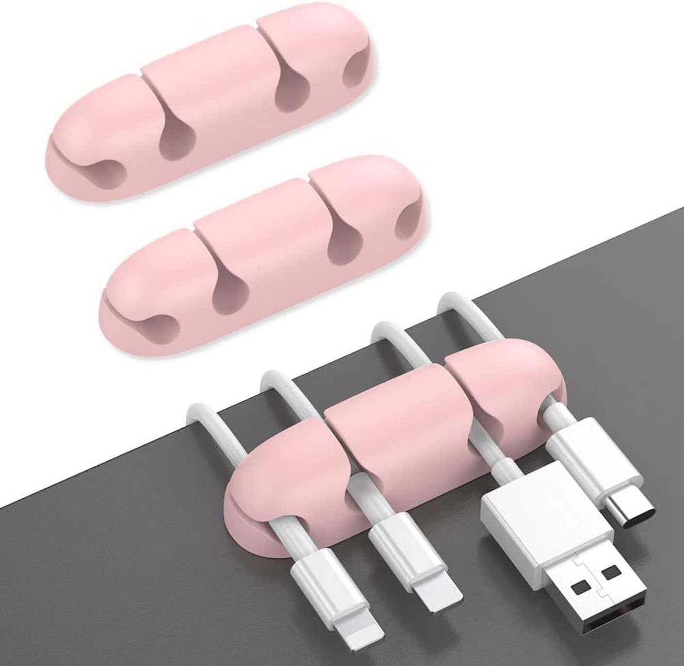 A pink cord holder separates four white cords.