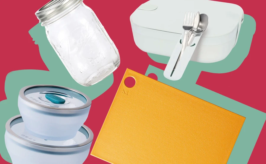 A mason jar, set of microwavable storage bowls, cutting board, and lunch box are collaged in front of a red background.