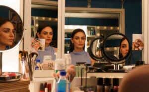 mila kunis in front of mirrors in Luckiest Girl Alive