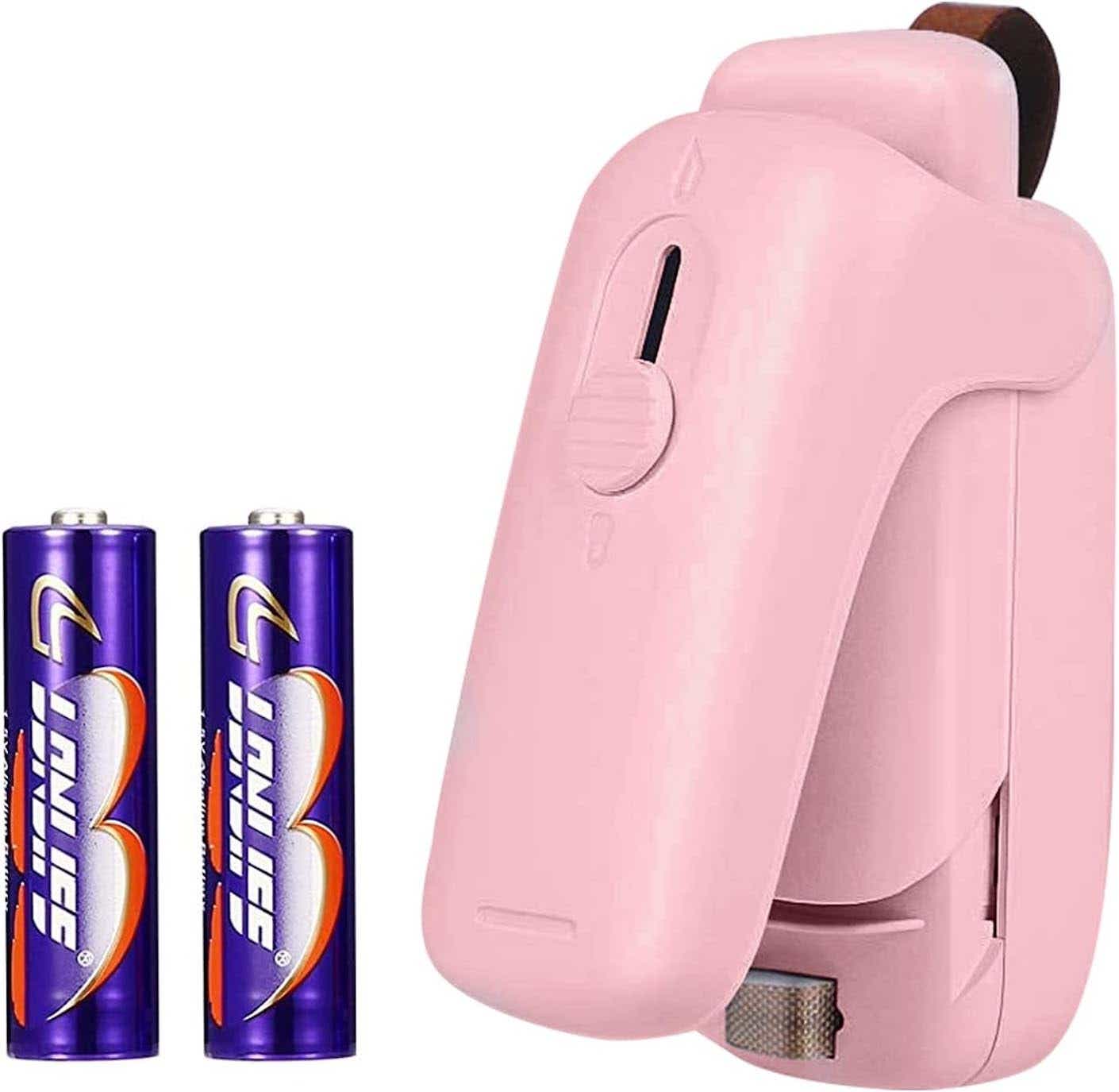 A pink mini bag sealer pictured alongside two AA batteries