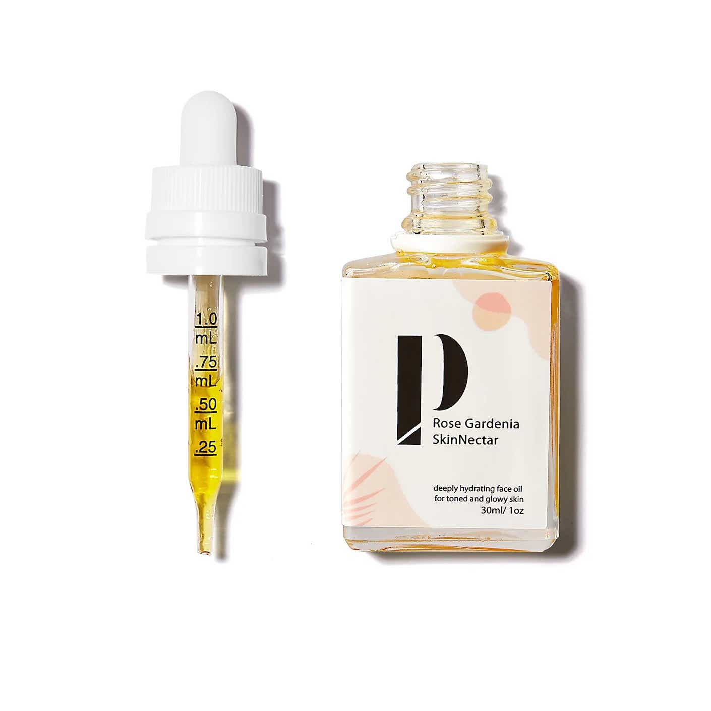 A glass square bottle of serum is pictured alongside a dropper full of the serum.