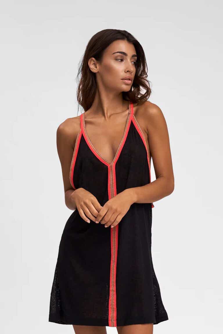 A woman wears an extremely lightweight beach coverup dress with spaghetti straps.