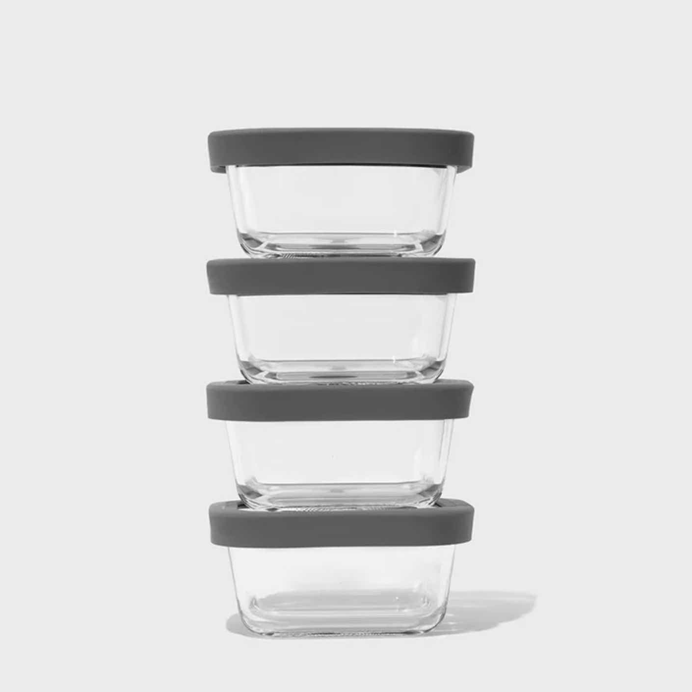 Four transparent containers for food storage are stacked on top of each other.