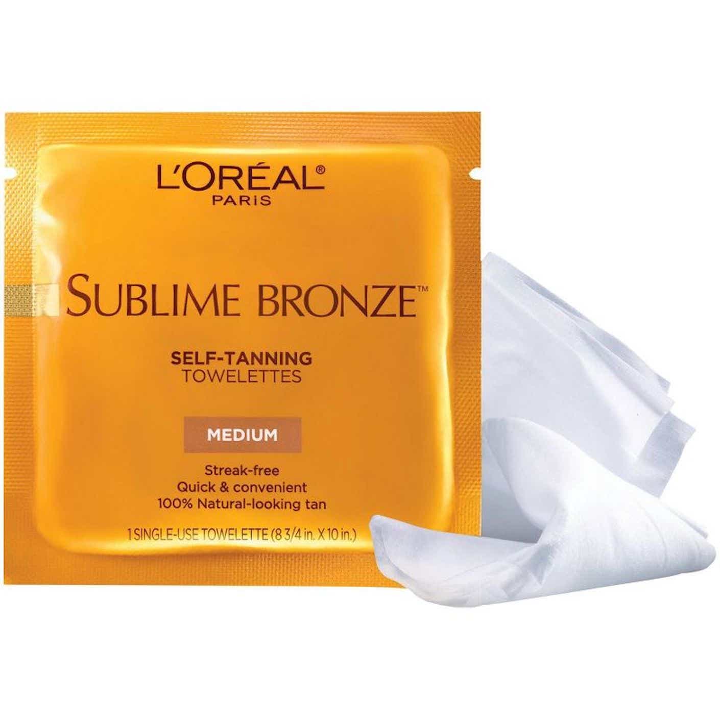 A flat, plastic, metallic orange packet holds a self tanning towelette.