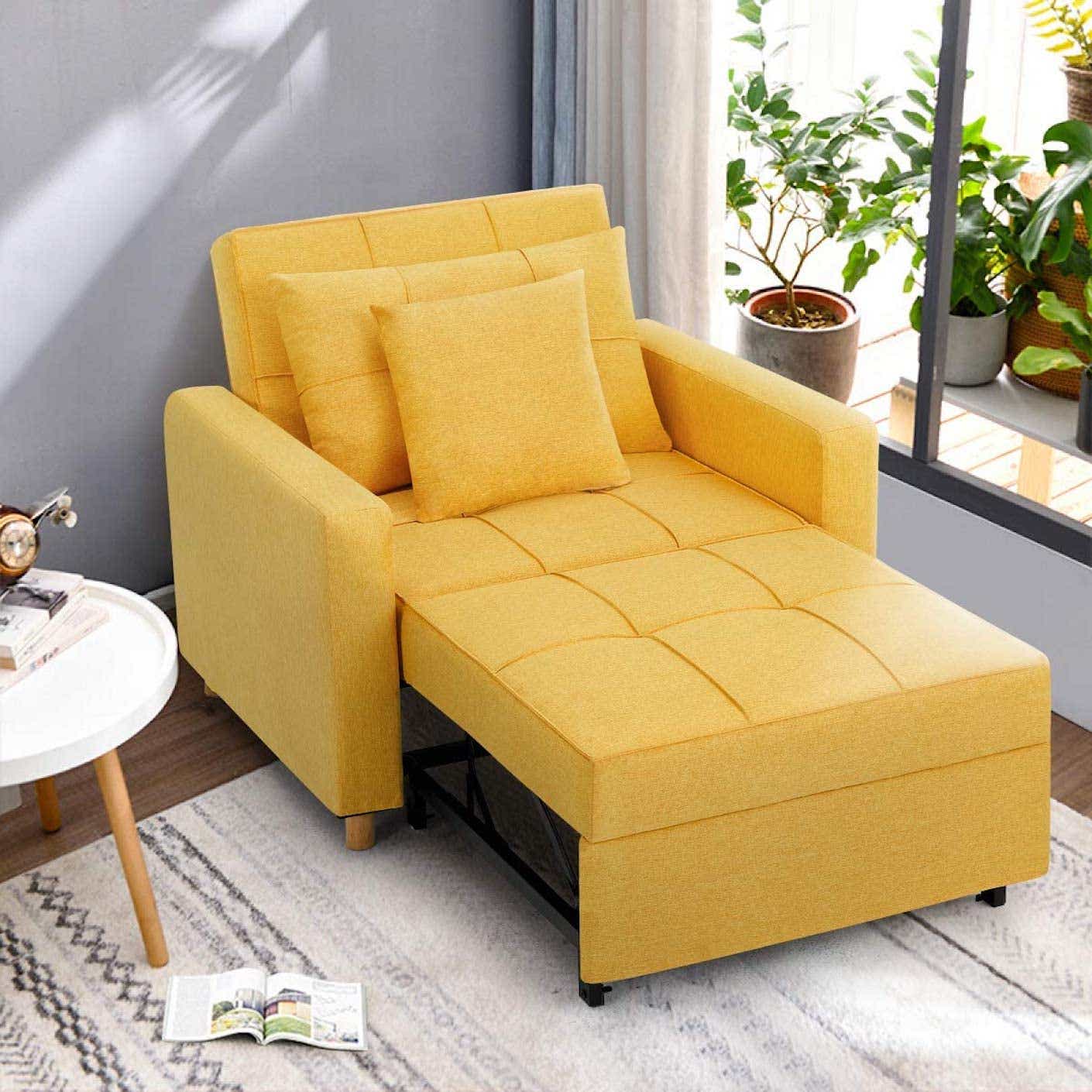 A yellow convertible chair is pulled out to be a long chair bed.