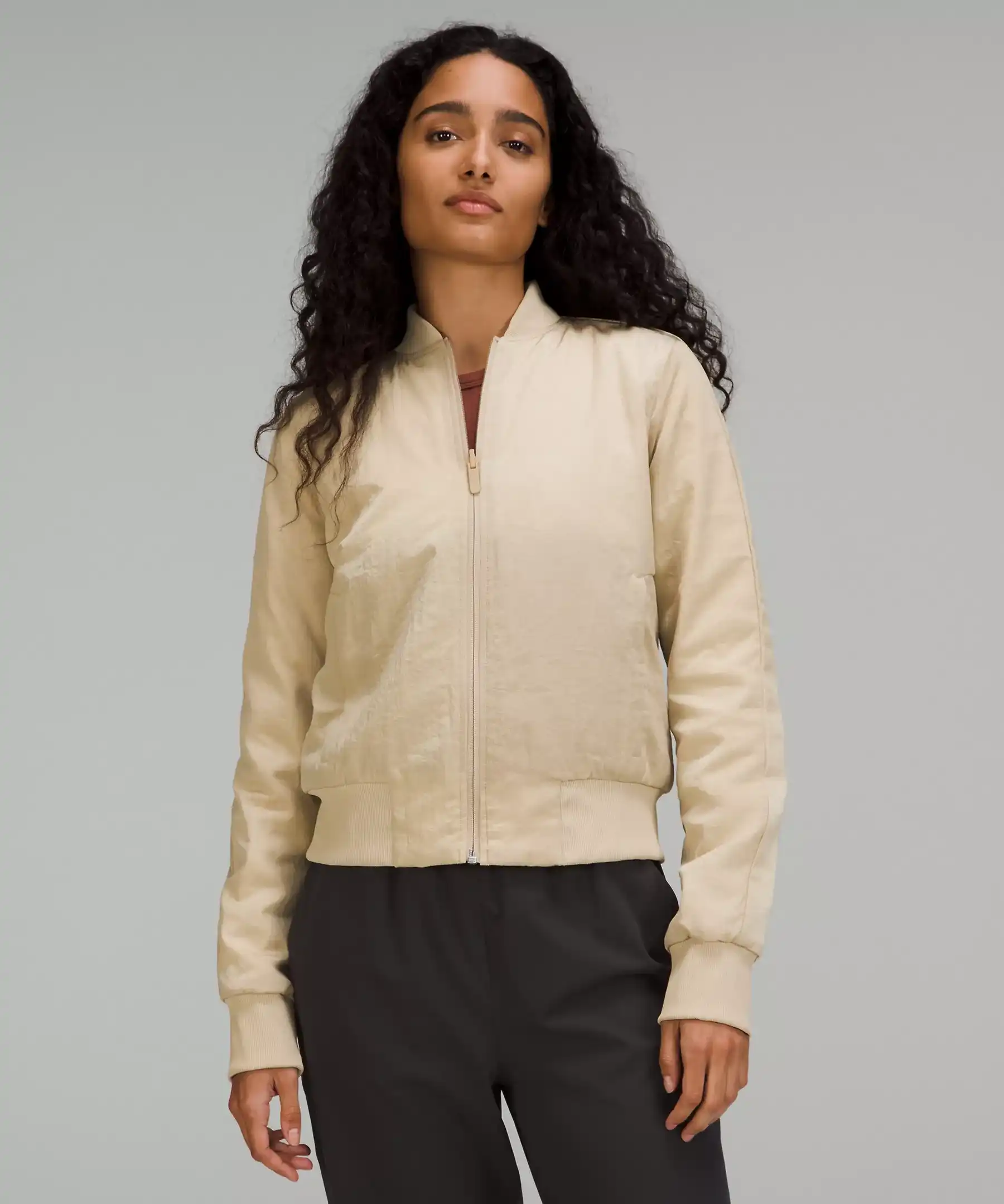 model wearing khaki bomber jacket
