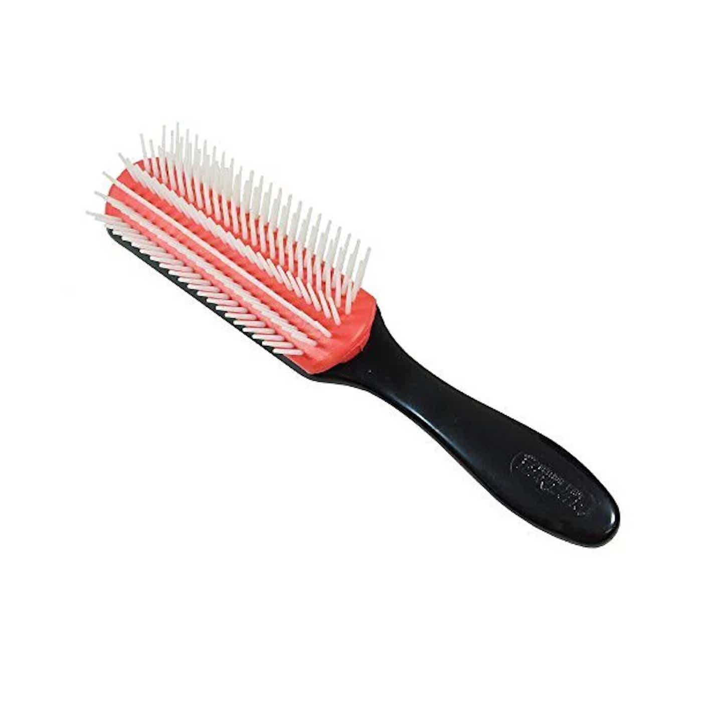 A black handled, red brush with white plastic bristles sits on a white surface.