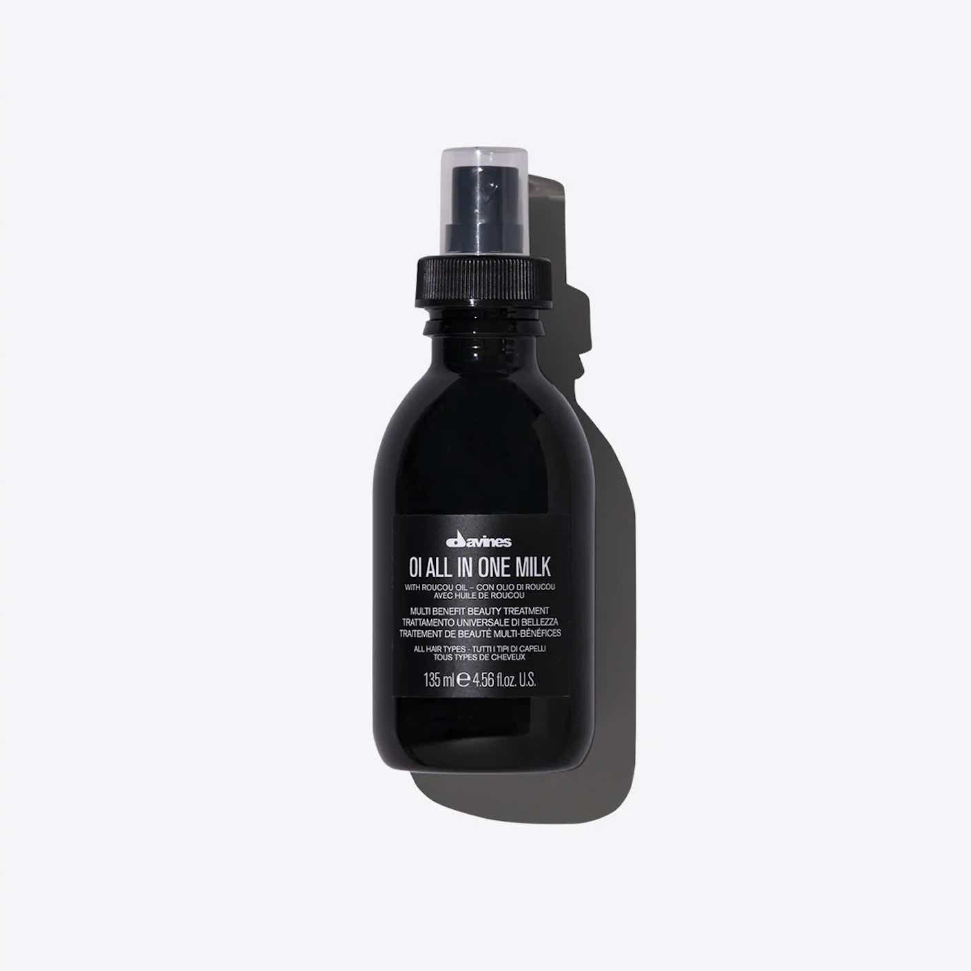A black plastic bottle of spray on hair milk is pictured.