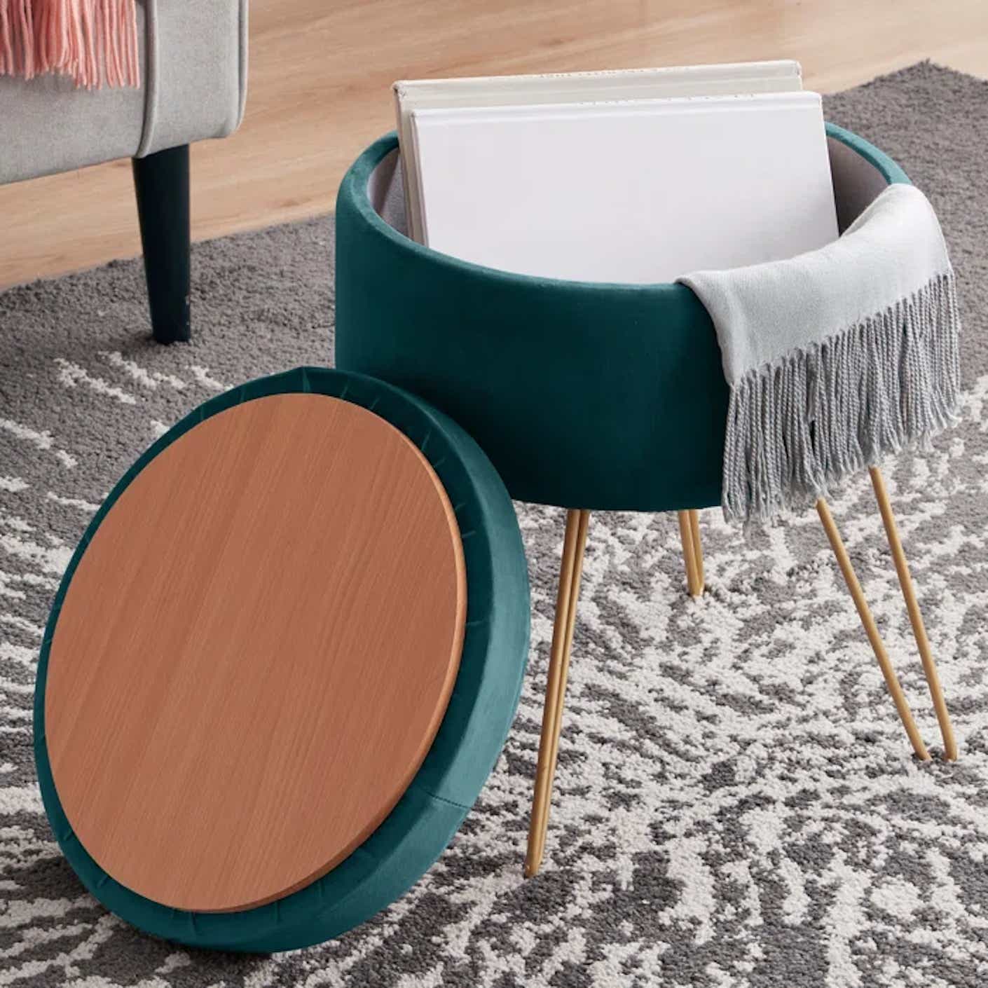 A small, circular ottoman is open to reveal storage space and a reversible lid.