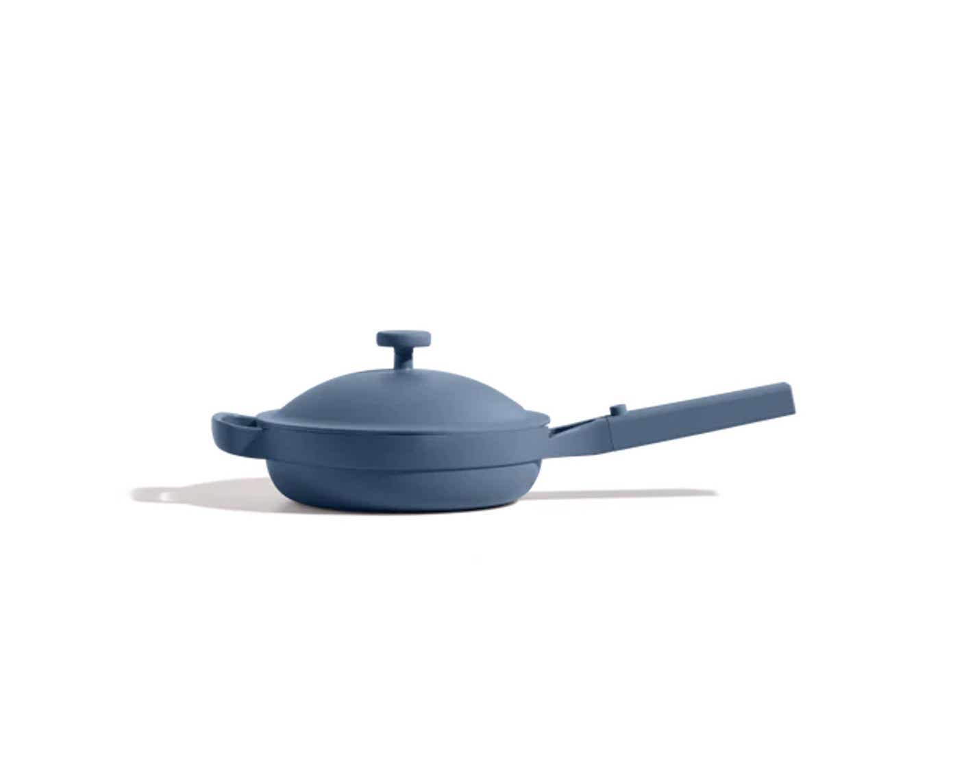 A blue, lidded pan sits in front of a white background.