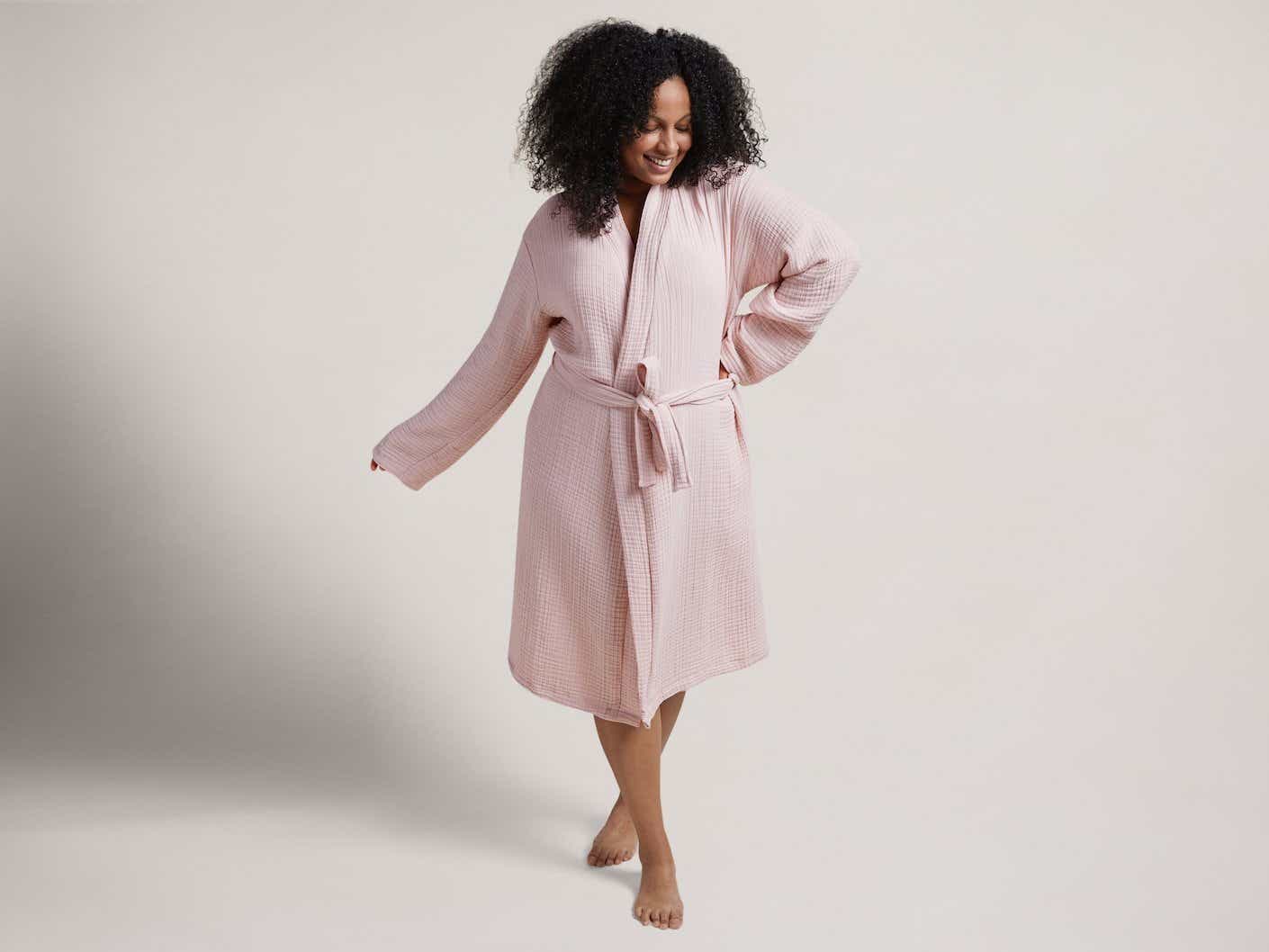 A woman wears a soft, lightweight, mid length robe.