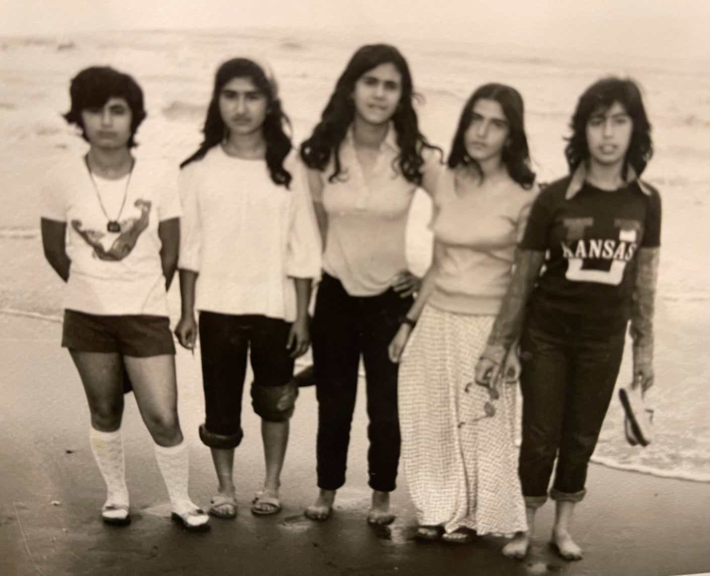 a group of young iranian women on the beach in the 1970s