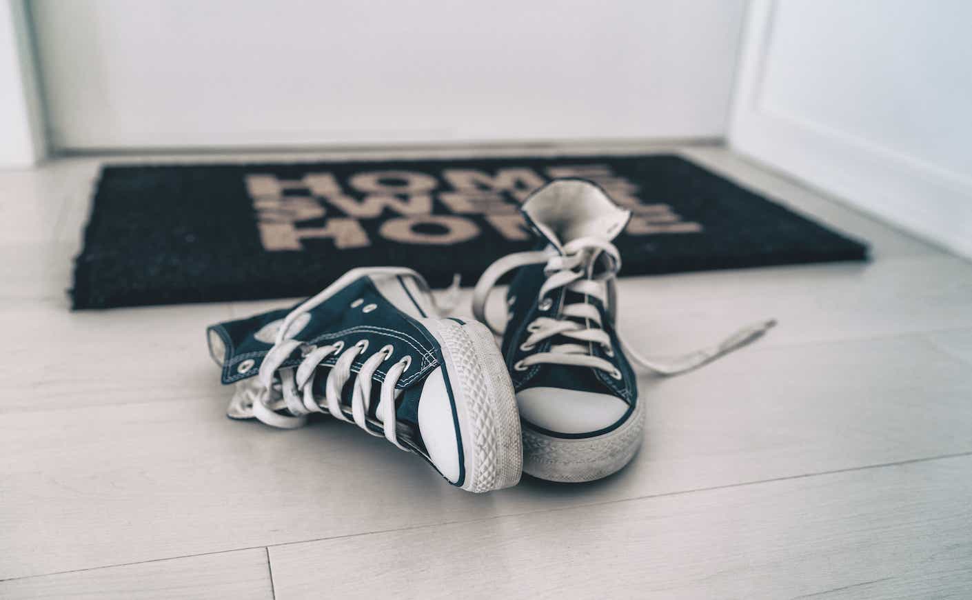 a pair of converse by the door