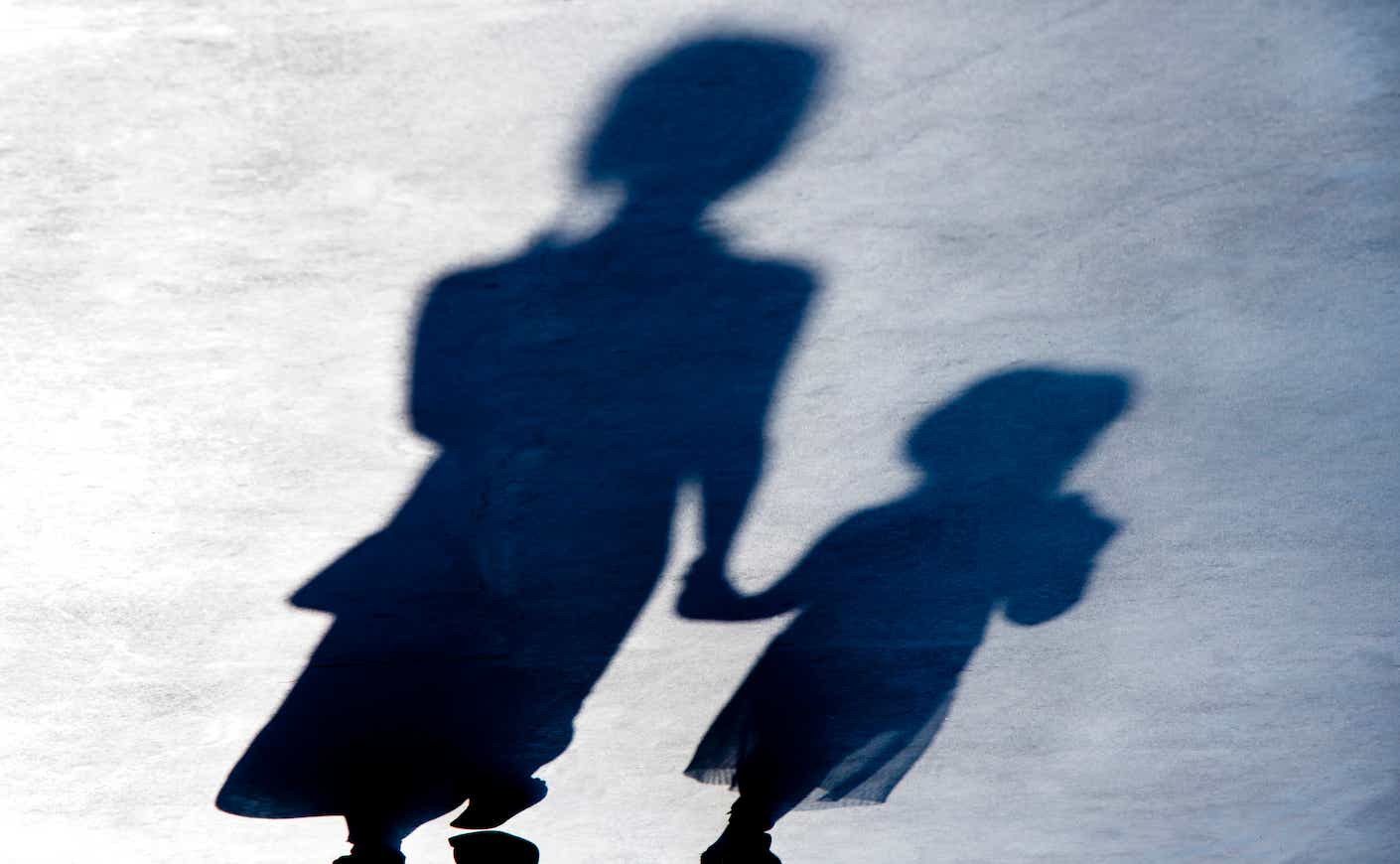 shadows of two young girls holding hands