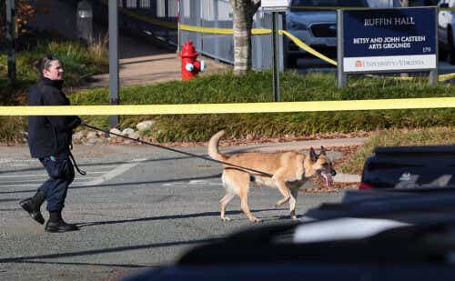 A law enforcement K9 team works the crime scene where 3 people were killed and 2 others wounded on the grounds of the University of Virginia on November 14, 2022 in Charlottesville, Virginia.