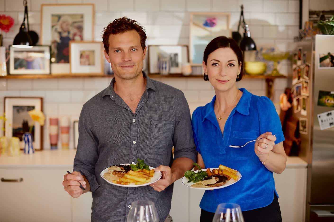 Jamie Dornan and Mary McCartney in the kitchen holding plate of mushroom steak