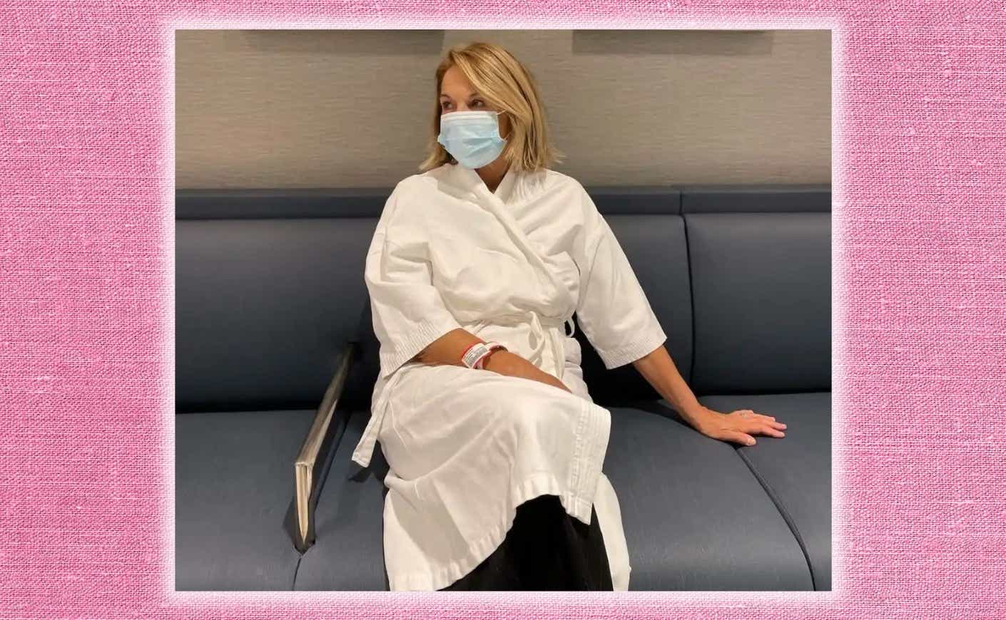 Katie Couric sits in a hospital wearing a face mask and white robe.