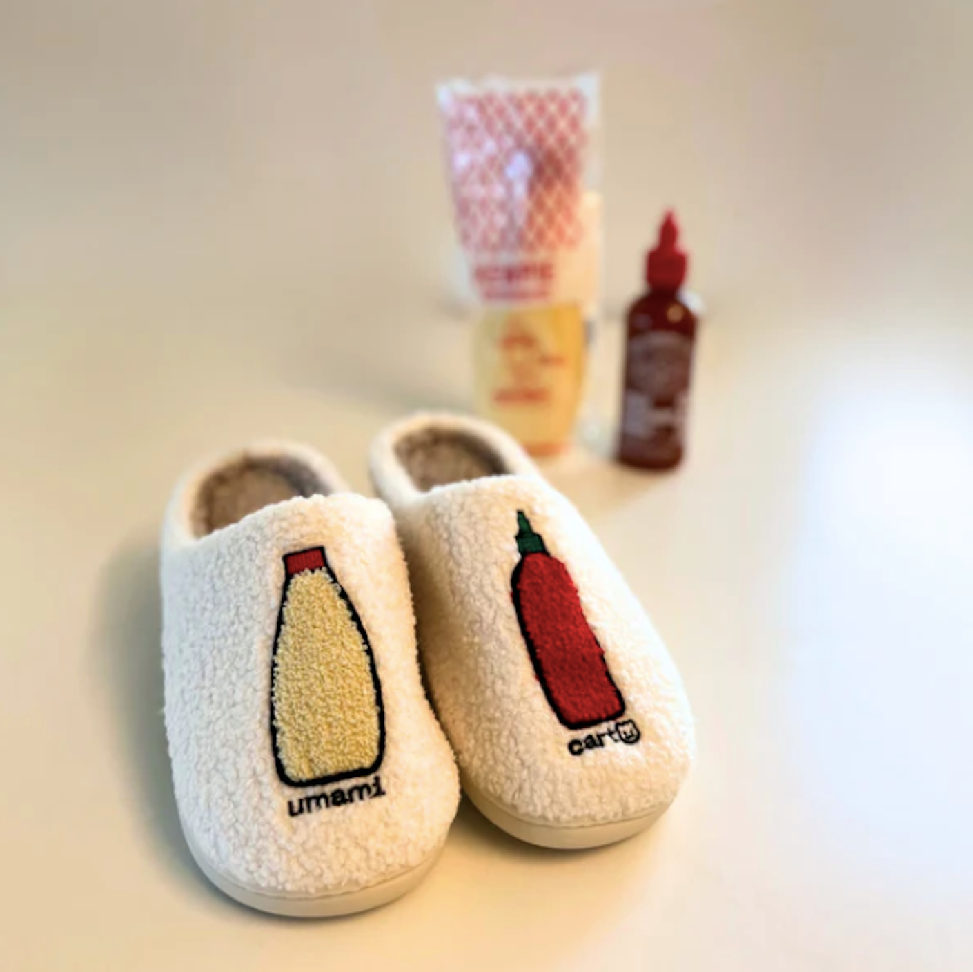 a pair of slippers in the foreground with mayo and siracha in the background
