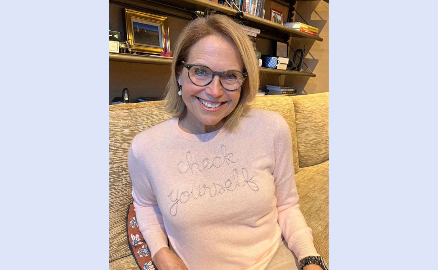 katie couric wearing a lingua franca sweater that says "check yourself"