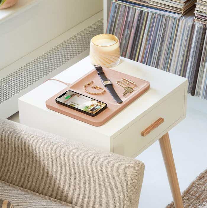 side table with a charging page and devices on it