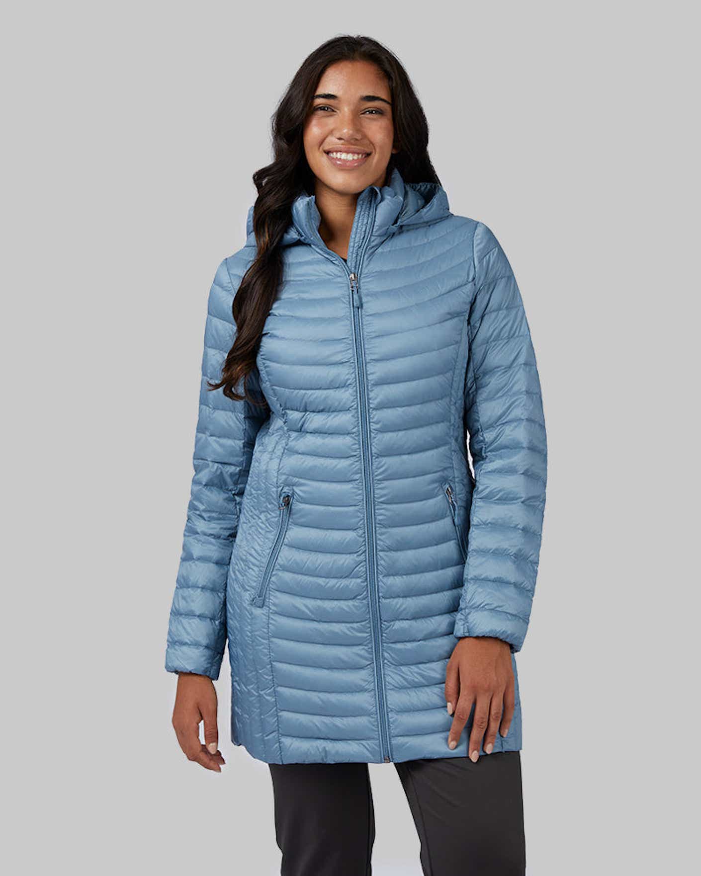 a smiling person wears a down jacket