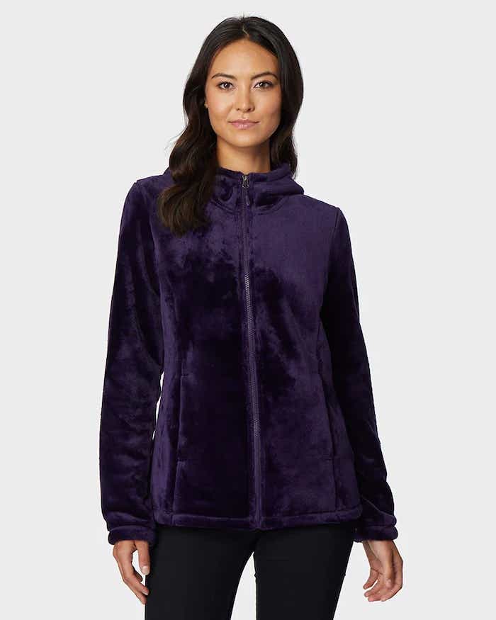 A woman wears a faux fur fleece.
