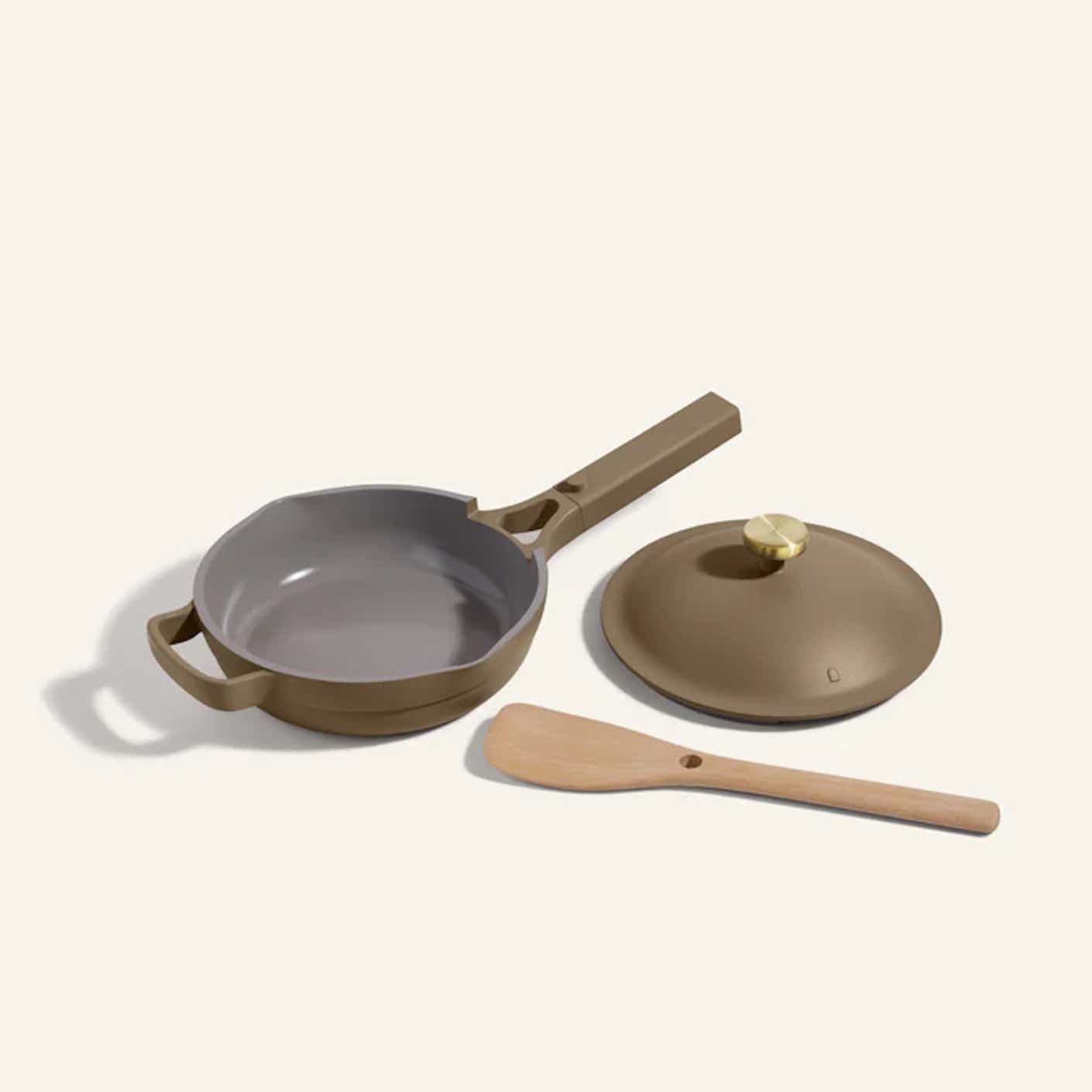 a skillet pan with a lid and a spoon