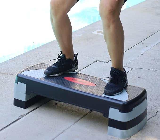 Person standing on gray and black aerobic stepper