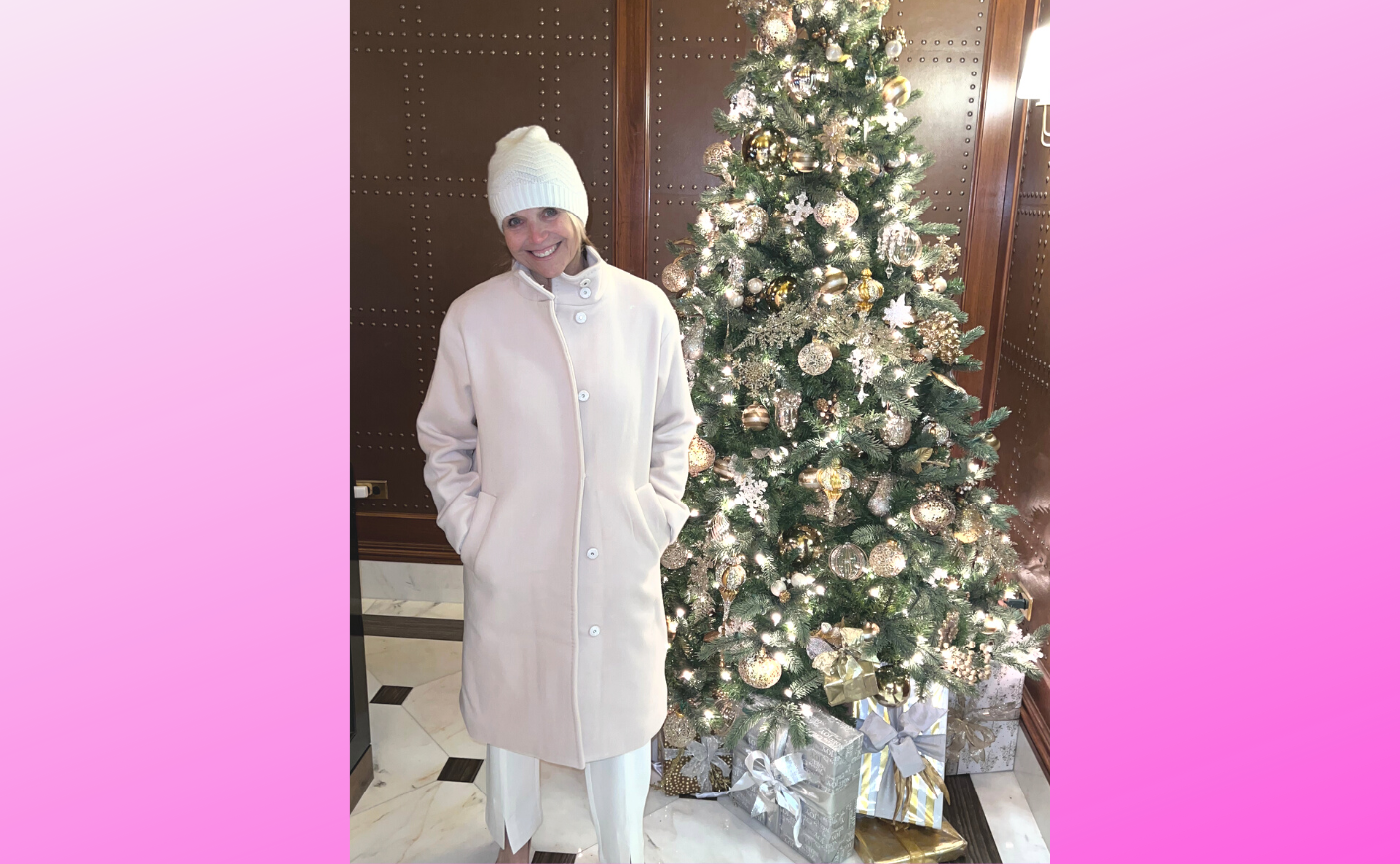 katie couric in a white outfit next to a christmas tree