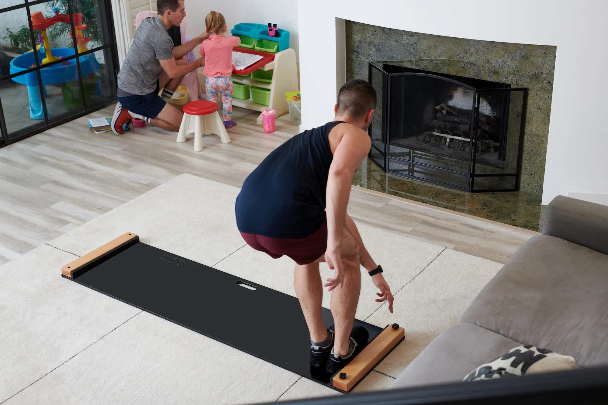A man using a Brrrn painting in the living room